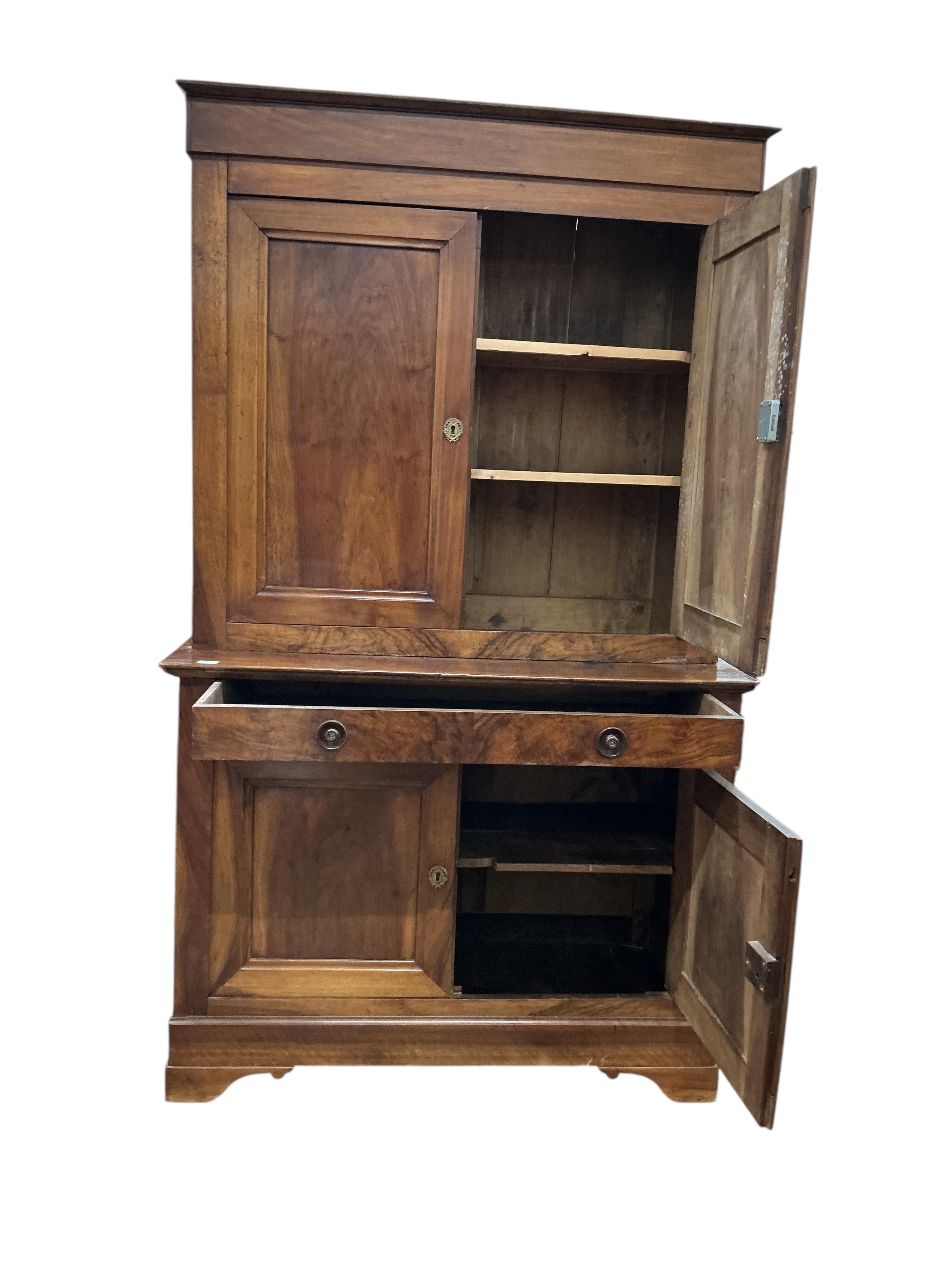 A 19th century French Biedermeier walnut side cabinet, width 125cm, depth 58cm, height 214cm